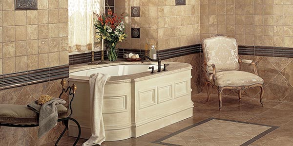 A bathroom tiled in natural-looking tan stone tile